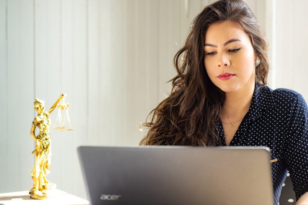 Working on a laptop for certified legal transcription services and accurate legal documentation.